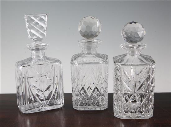 Three cut and moulded glass decanters and stoppers, largest 26cm